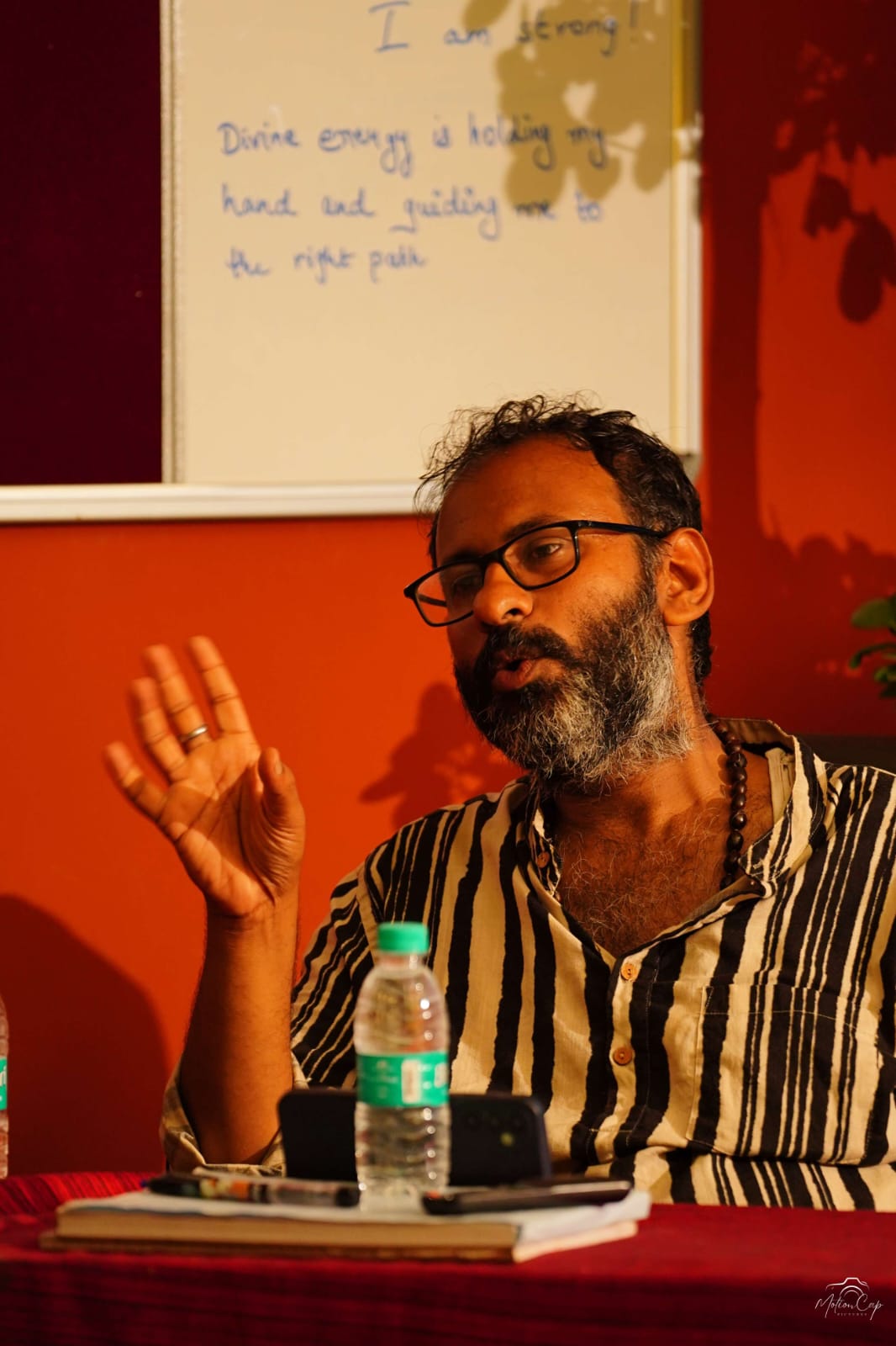 A teacher explaining yoga philosophy during a concept class