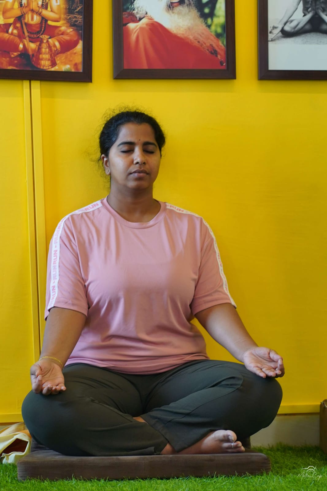 A student seated in quiet meditation in the practice hall