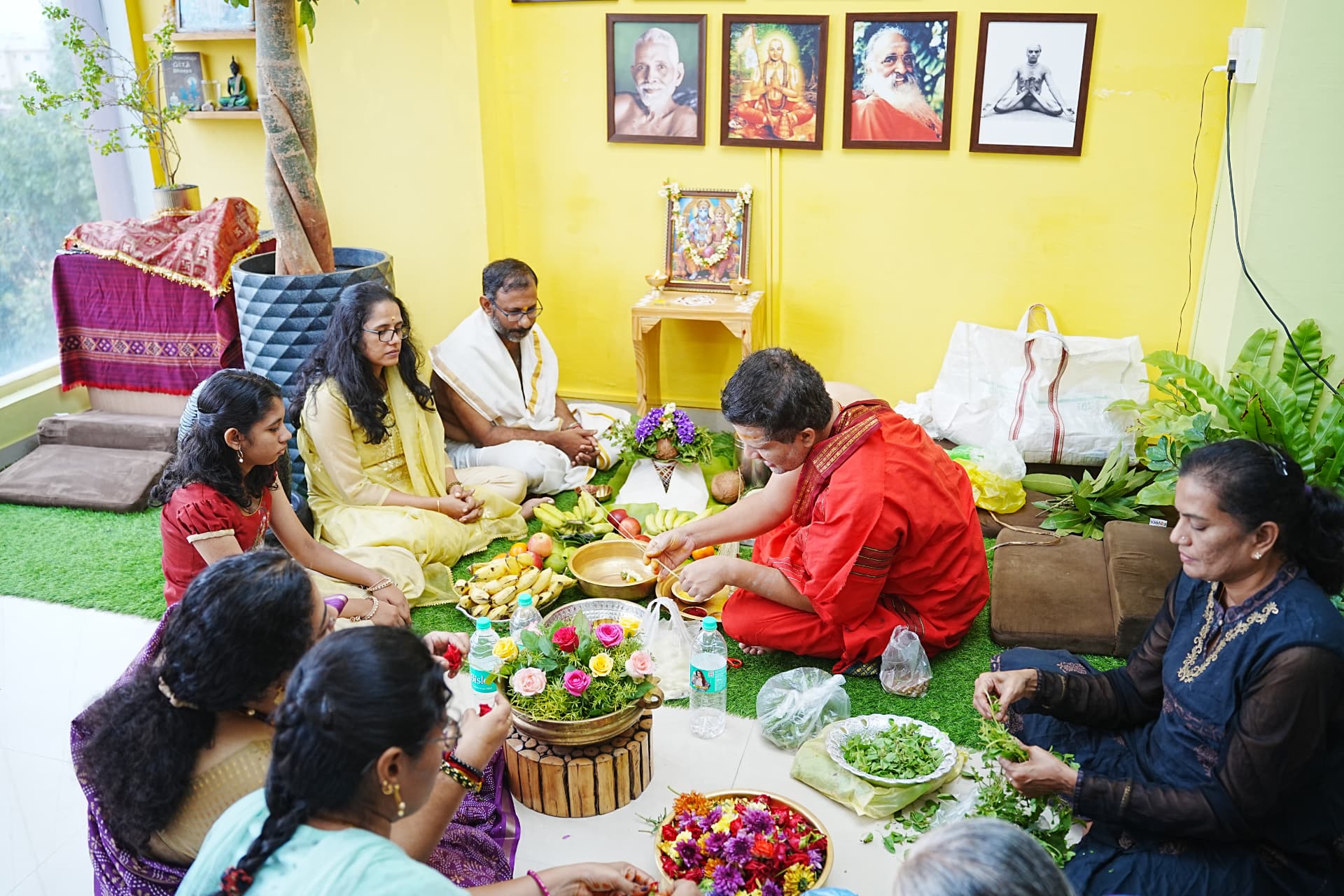 The Foundation Day puja, with offerings of fruit and flowers before the guru portraits
