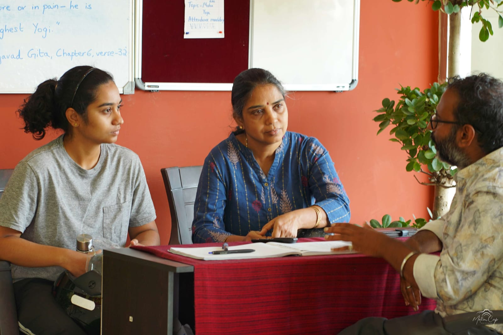 The teacher guiding students through relaxation in the practice hall